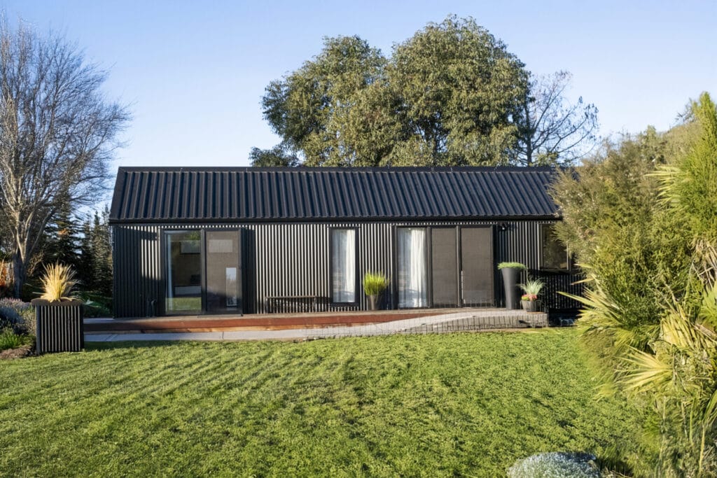 Everest XL 2 Bedroom Tiny Home by Fox Cabins with deck built onsite by client.