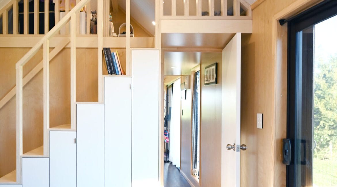 Everest XL 2 Bedroom Tiny Home by Fox Cabins with deck built onsite by client.