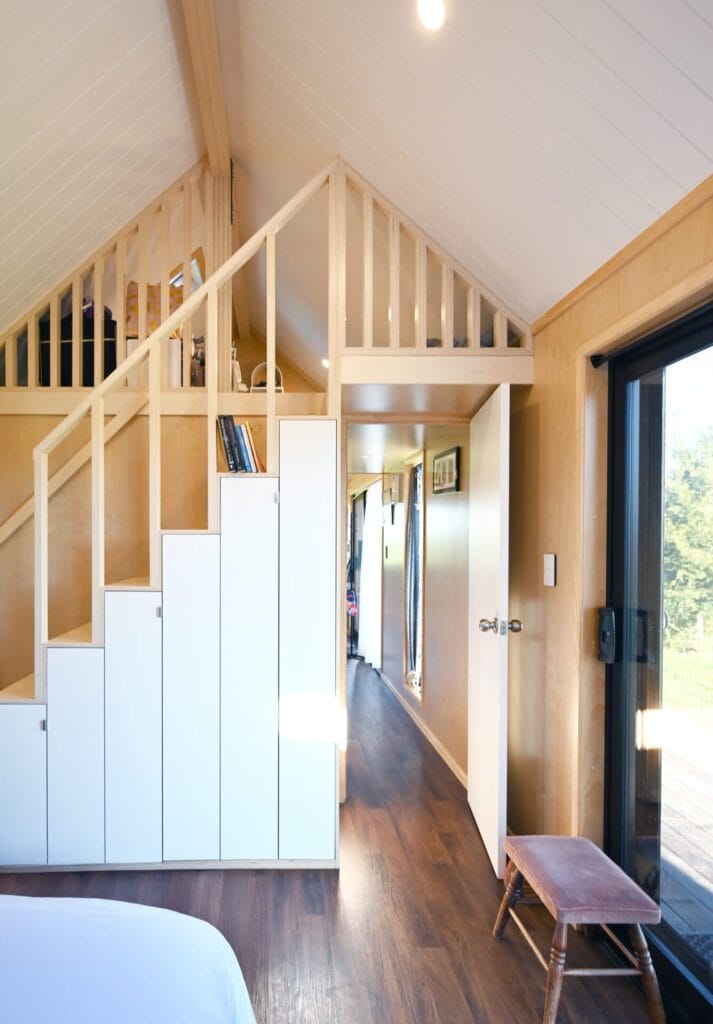 Everest XL 2 Bedroom Tiny Home by Fox Cabins with deck built onsite by client.