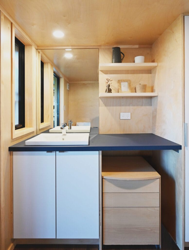 Everest XL 2 Bedroom Tiny Home by Fox Cabins with deck built onsite by client.