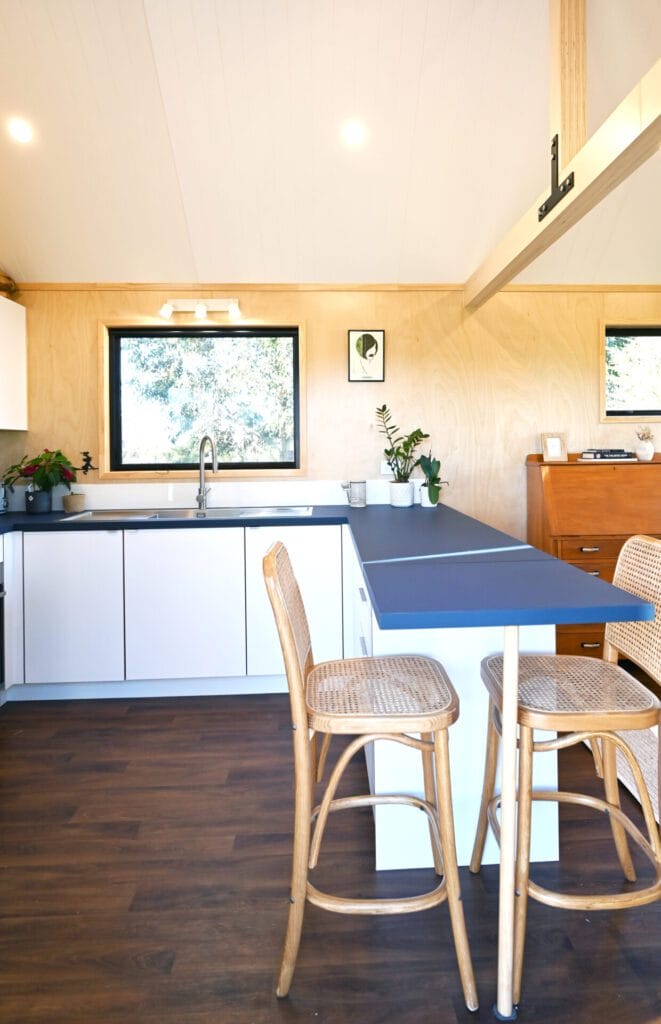 Everest XL 2 Bedroom Tiny Home by Fox Cabins with deck built onsite by client.