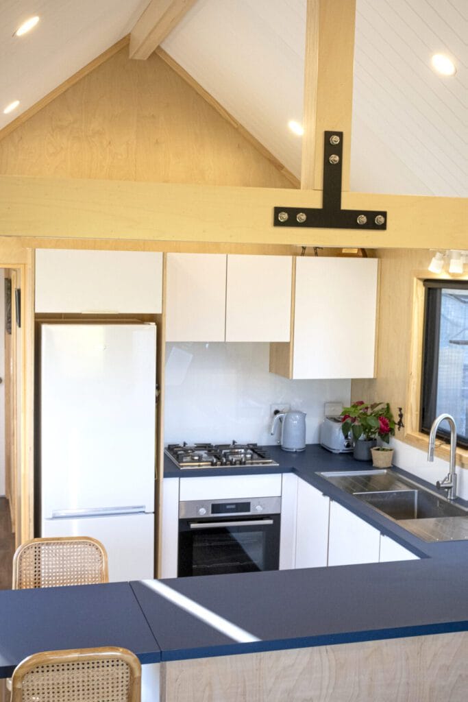 Everest XL 2 Bedroom Tiny Home by Fox Cabins with deck built onsite by client.