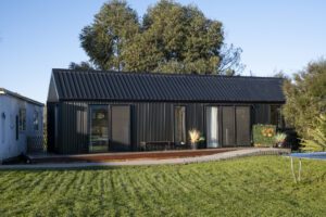 Everest XL 2 Bedroom Tiny Home by Fox Cabins with deck built onsite by client.